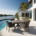 Outdoor poolside pavers with dining set that includes round faux aluminum dining table and four woven and aluminum dining chairs