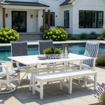 Outdoor marine grade polymer and sling dining set on a patio next to a pool